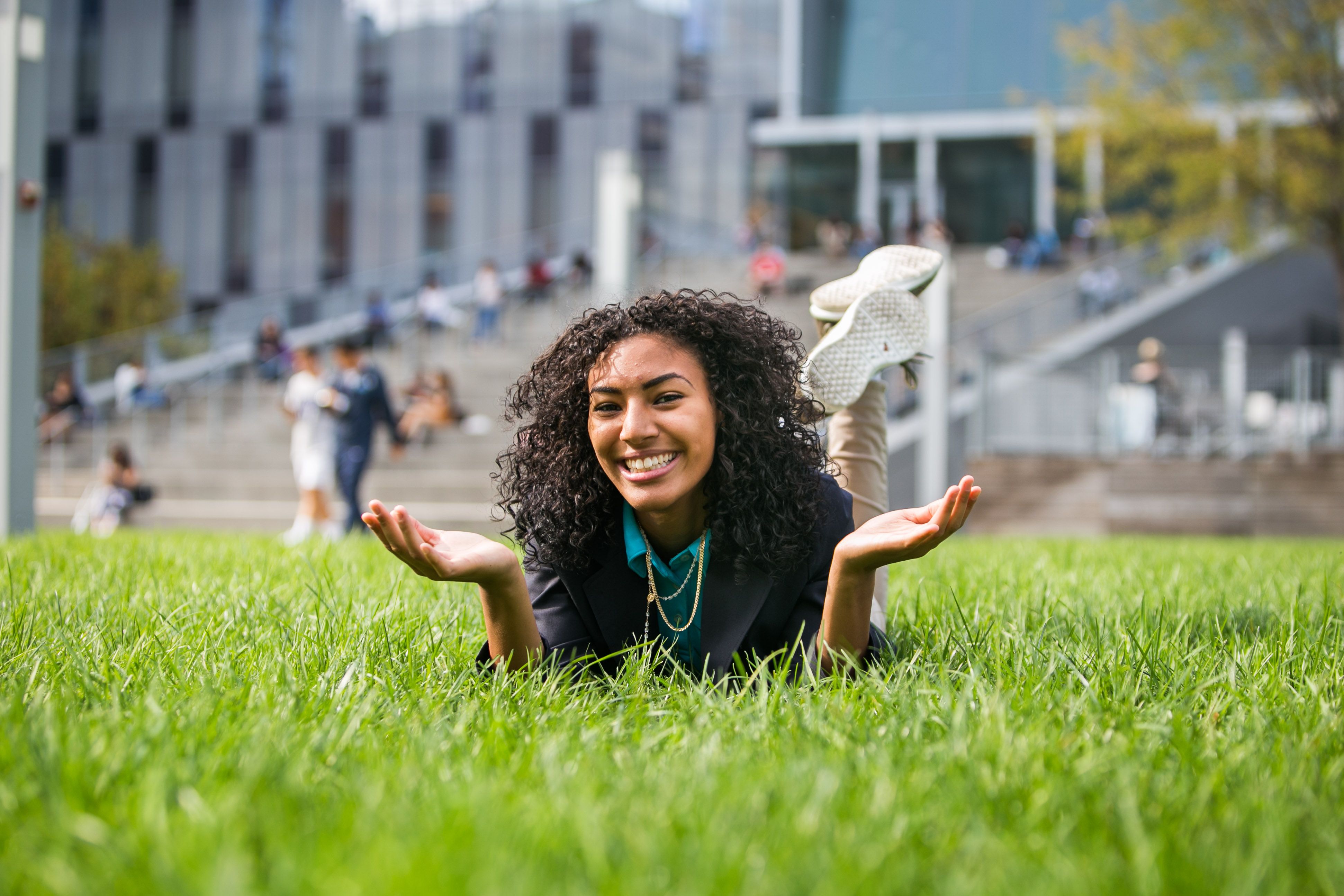 Smiling student in grass on Jay Walk.
