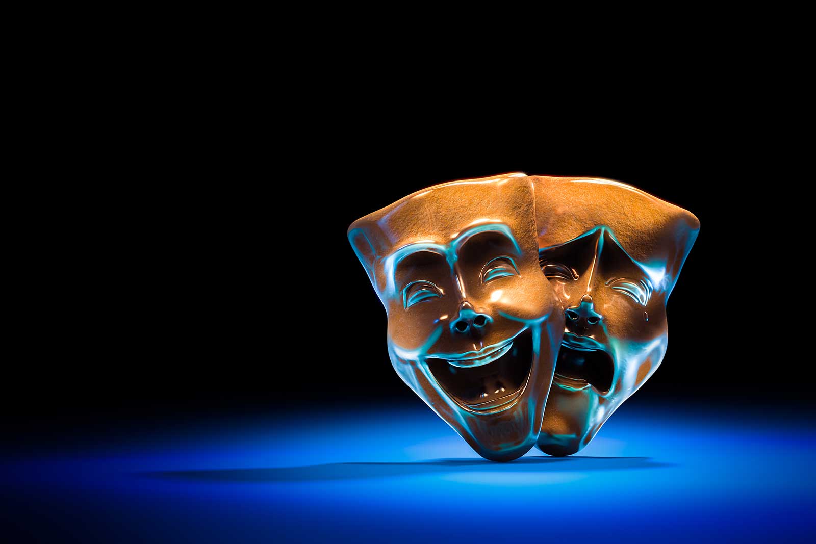 theatre masks, drama and comedy on a dark background