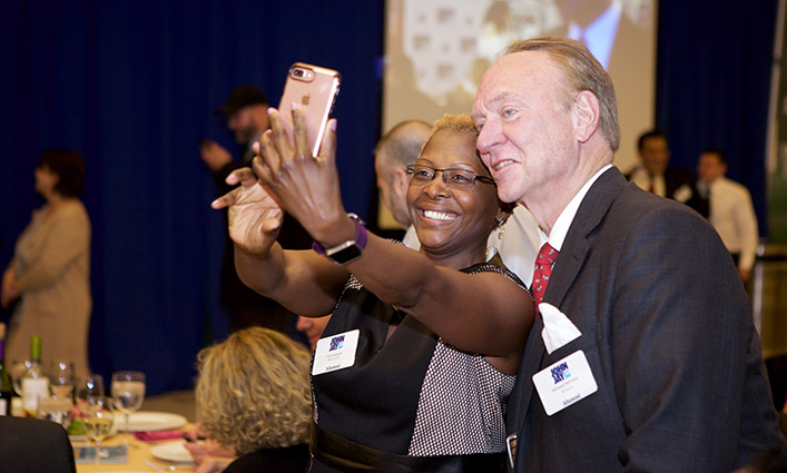Guests taking selfies at the Alumni Reunion