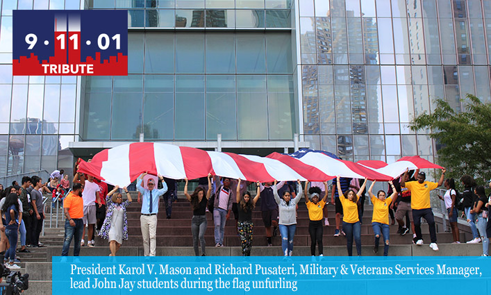 President Karol V. Mason and Richard Pusateri, Military & Veterans Services Manager, lead John Jay students during the flag unfurling