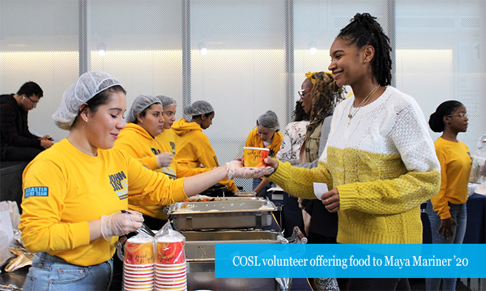 COSL volunteer offering food to Maya Mariner ’20