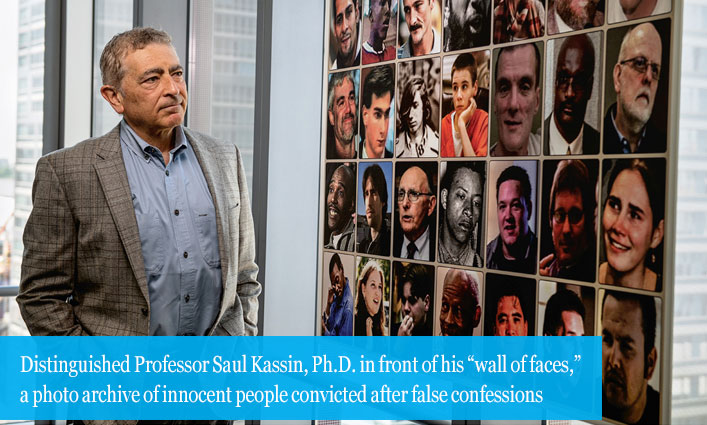 Distinguished Professor Saul Kassin, Ph.D. in front of his “wall of faces,” a photo archive of innocent people convicted after false confessions