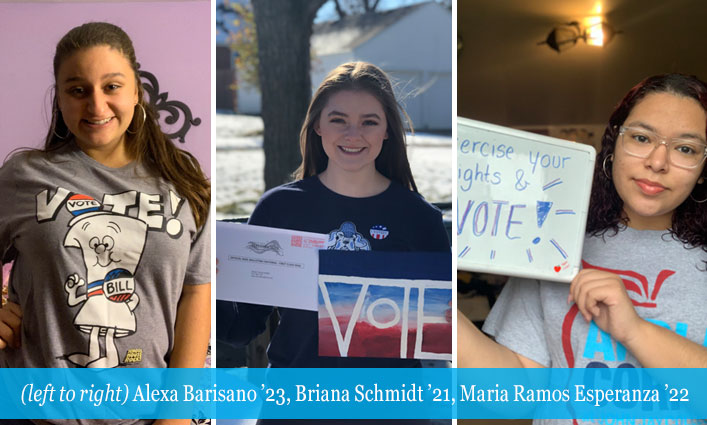 3 girls holding up voting signs