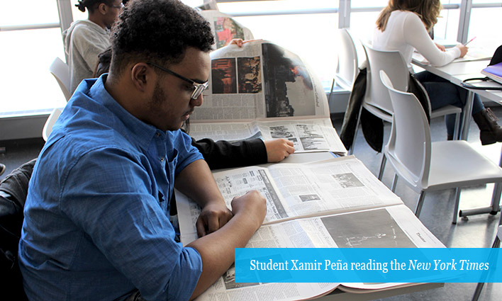John jay students reading newspaper