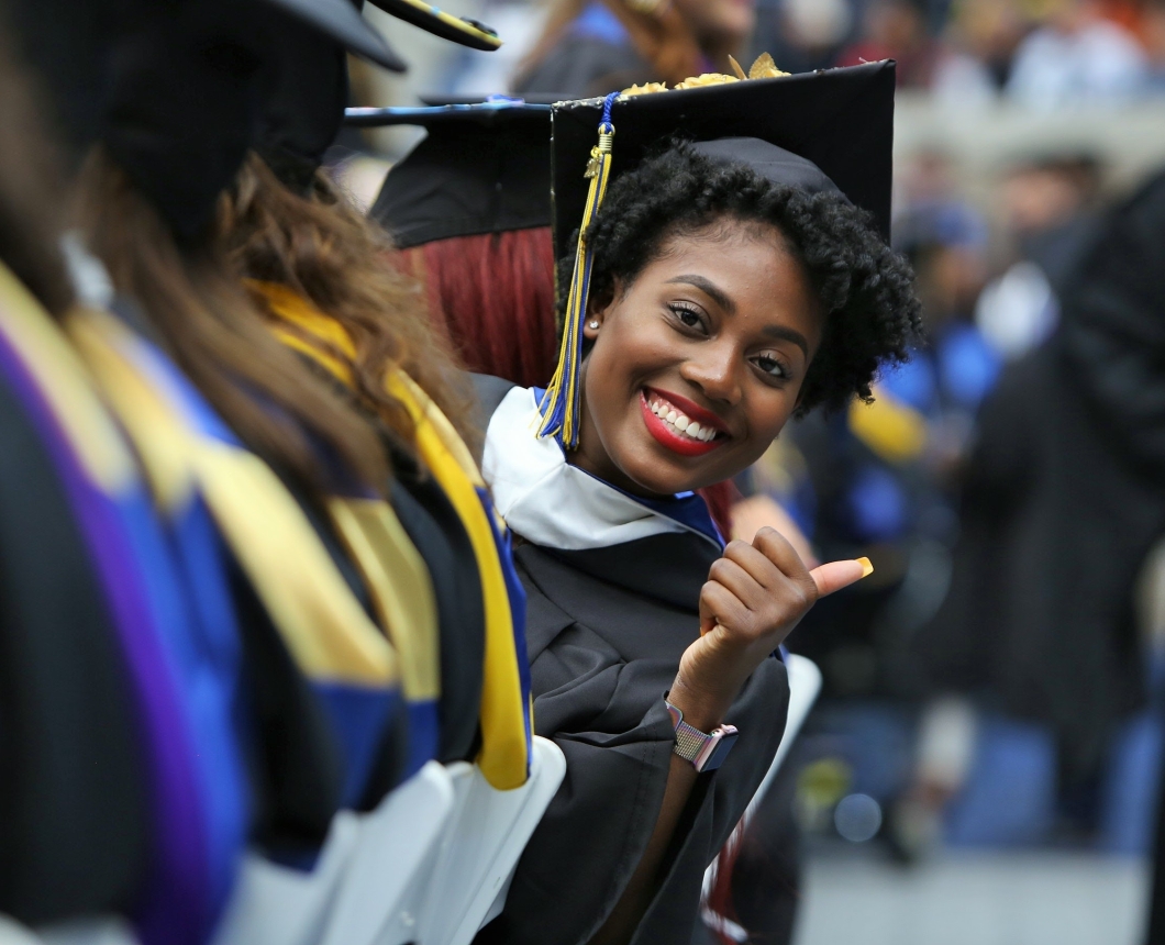 Student giving thumbs up at Commencement