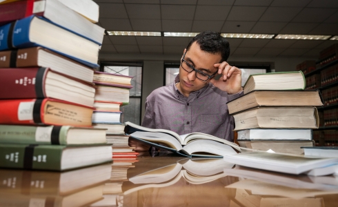 Person with books in library