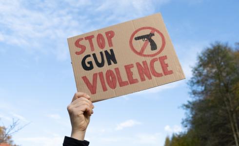 Person holding "Stop Gun Violence" Sign