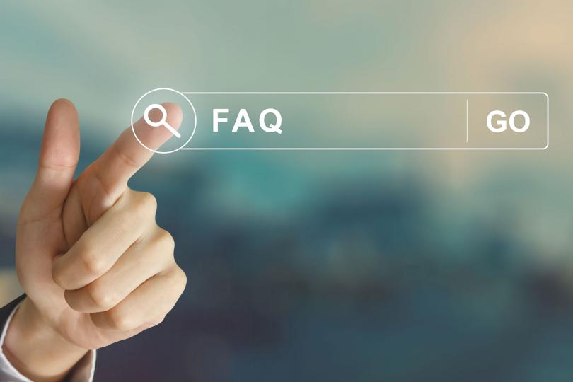 business hand clicking FAQ or Frequently asked questions button By pichetw