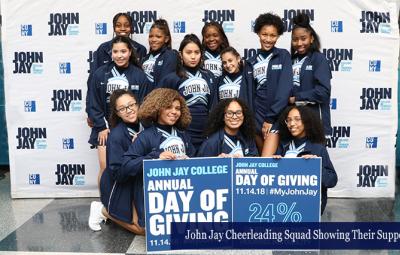 John Jay Cheerleading Squad Showing Their Support at the Annual Day of Giving