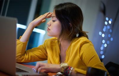 Woman looking stressed at the computer