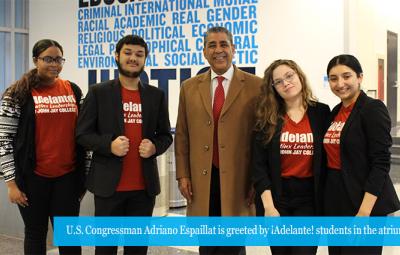 U.S. Congressman Adriano Espaillat is greeted by Adelante students in the atrium