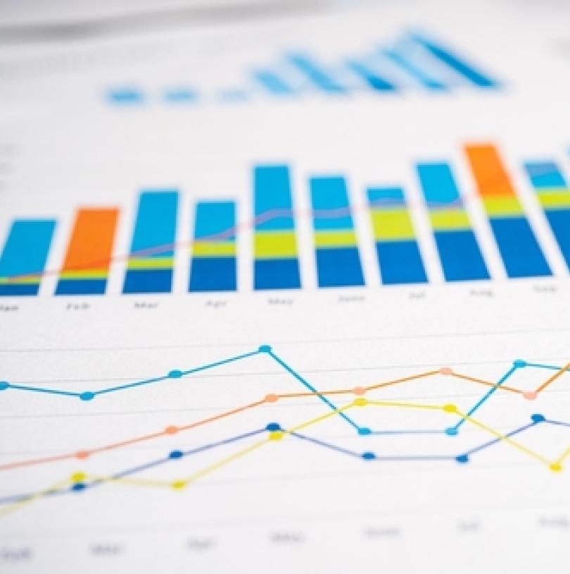 paper showing data in a bar chart and graph